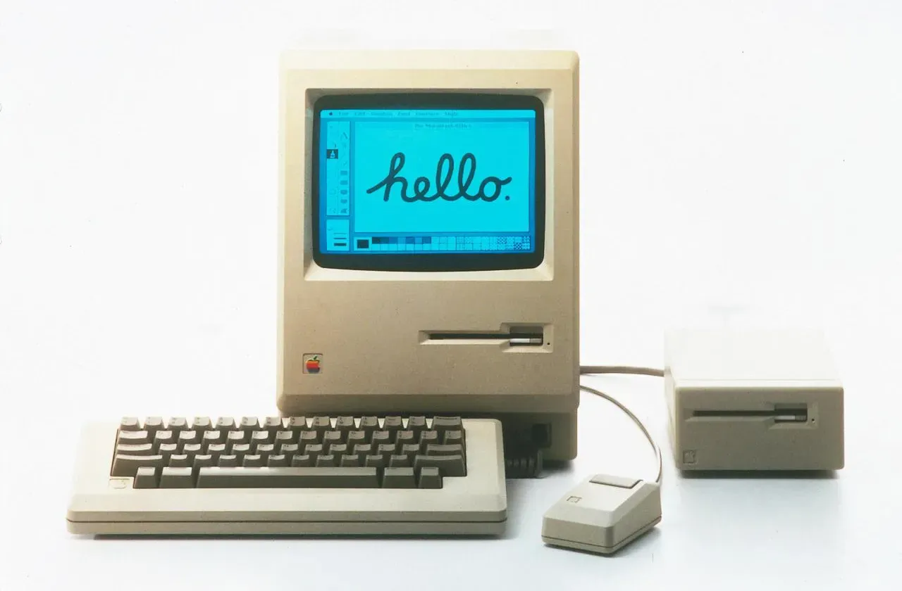 Original 1984 Macintosh computer displaying 'hello' on screen